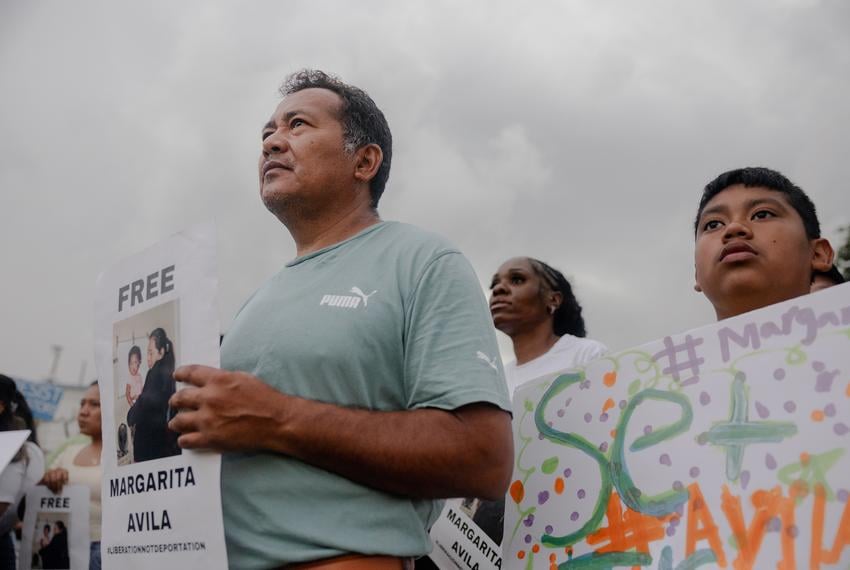 José and his son, Isaac attend a FIEL action in front of the Core Civic Processing Center where Margarita Avila and others are being detained, Friday, June 13, 2025, in Houston. The action focused on the increase in detentions, and let those inside the facility feel that they were not alone. 

(Lexi Parra for The Texas Tribune)